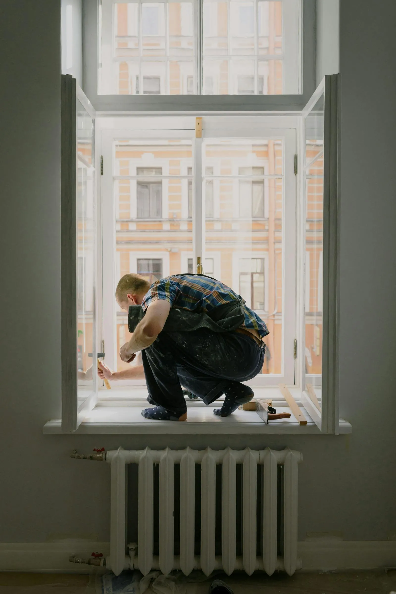 Skilled worker repairing and installing a residential window